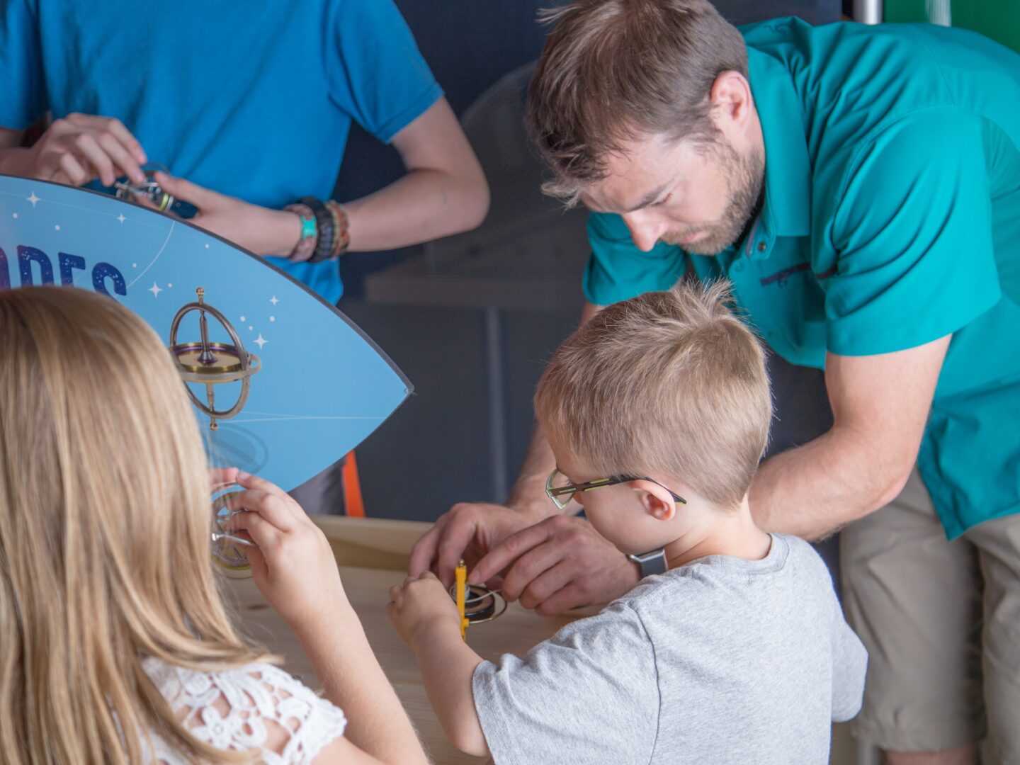 Father & son do a hands-on activity in Mission Aerospace exhibit