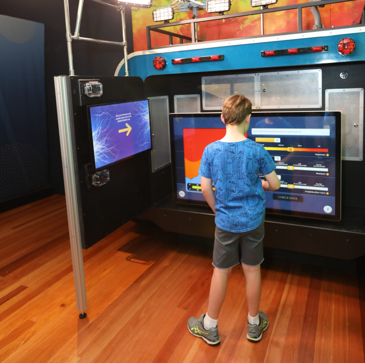 A child is standing in front of an electricity exhibit.