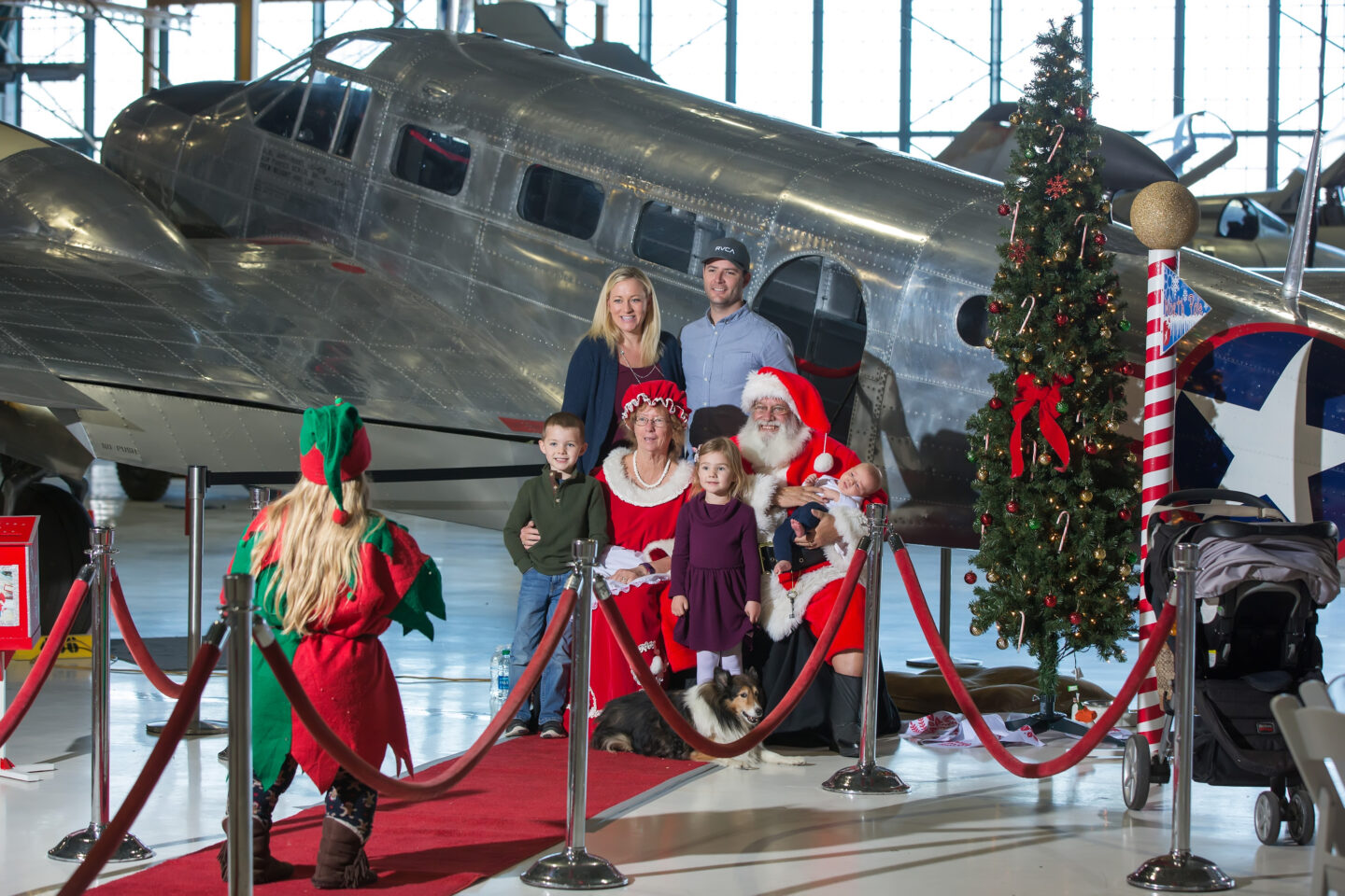 Family photo with Santa in front of an airplane