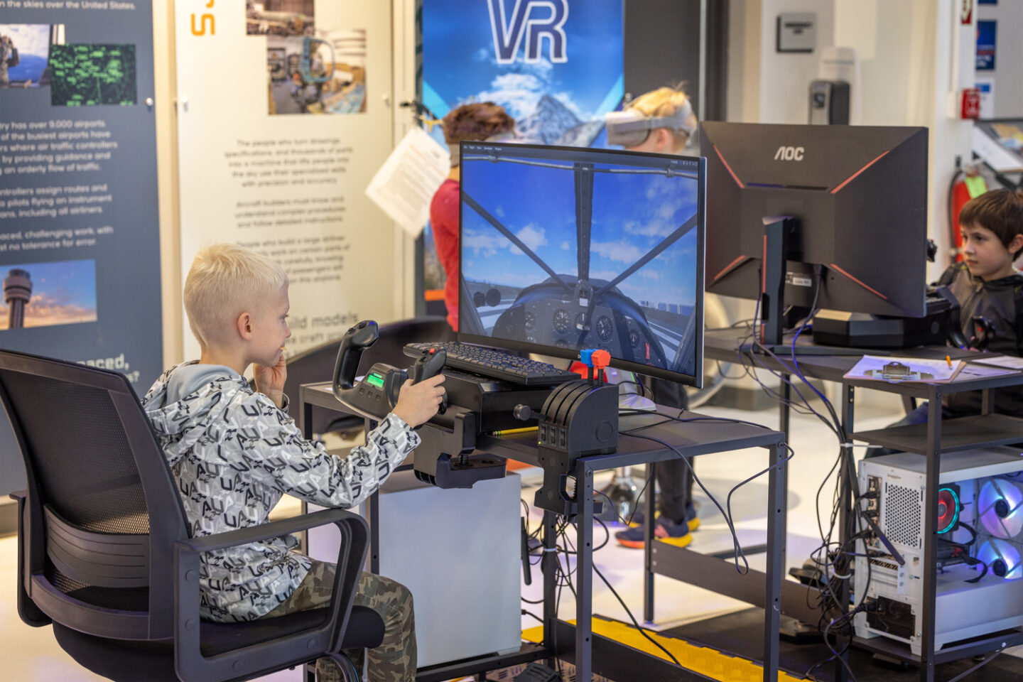 Guests using a simulator at Exploration of Flight