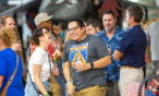 Young couple holding drinks and laughing at the Air & Space Museum