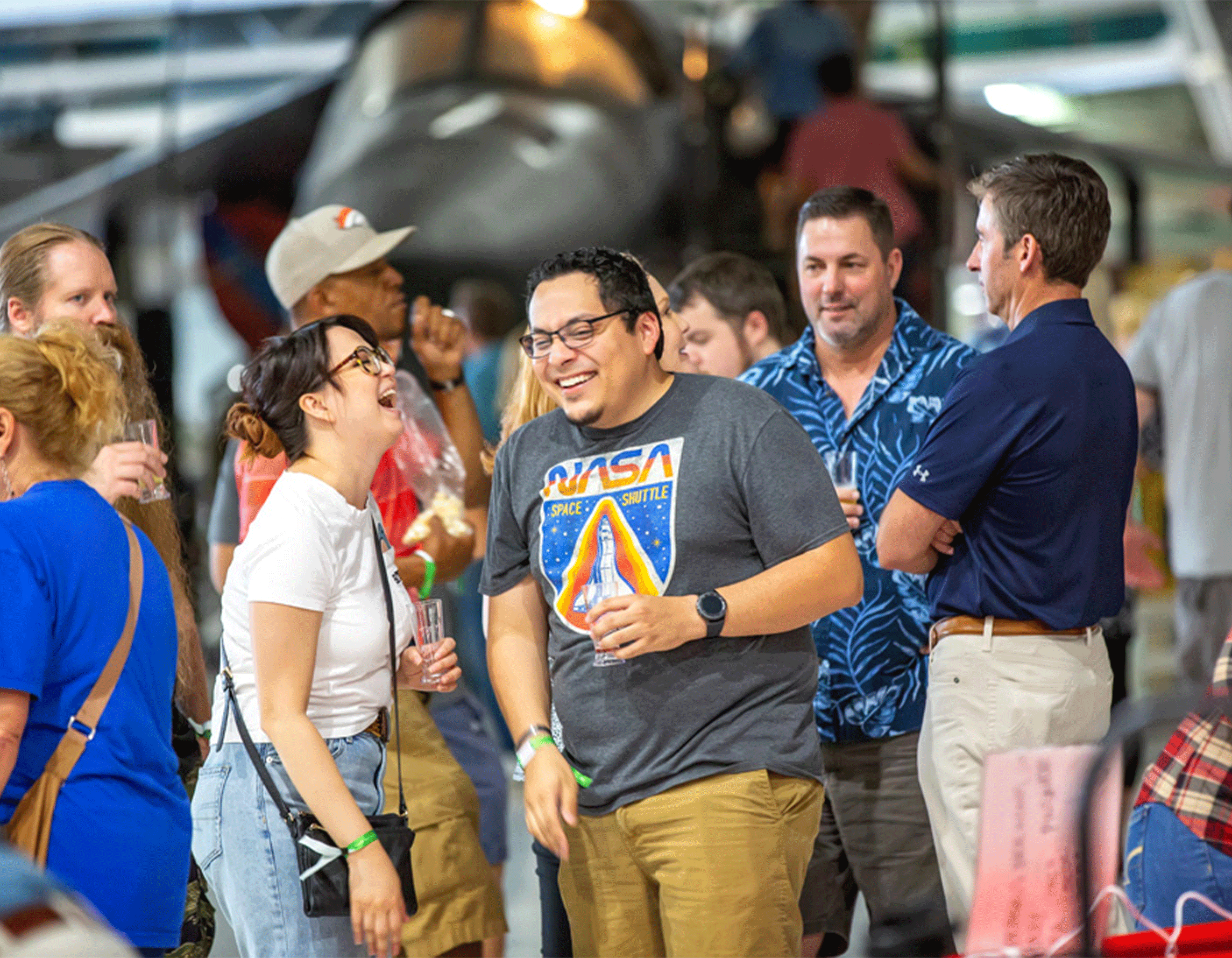 Young couple holding drinks and laughing at the Air & Space Museum