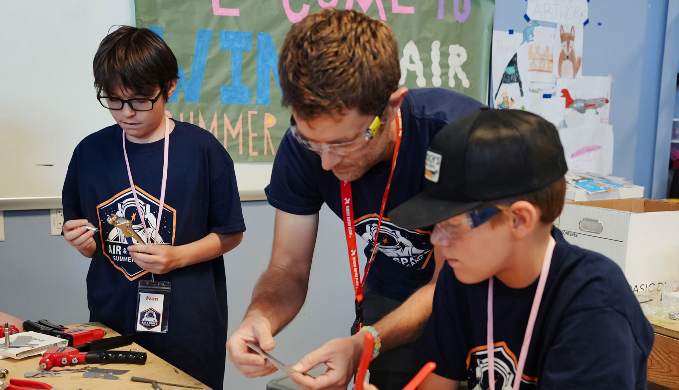 Campers building a model airplane