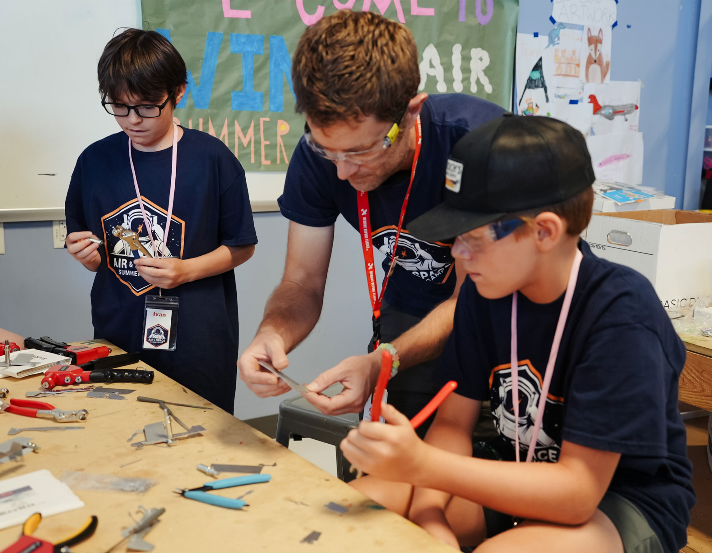 Campers building a model airplane