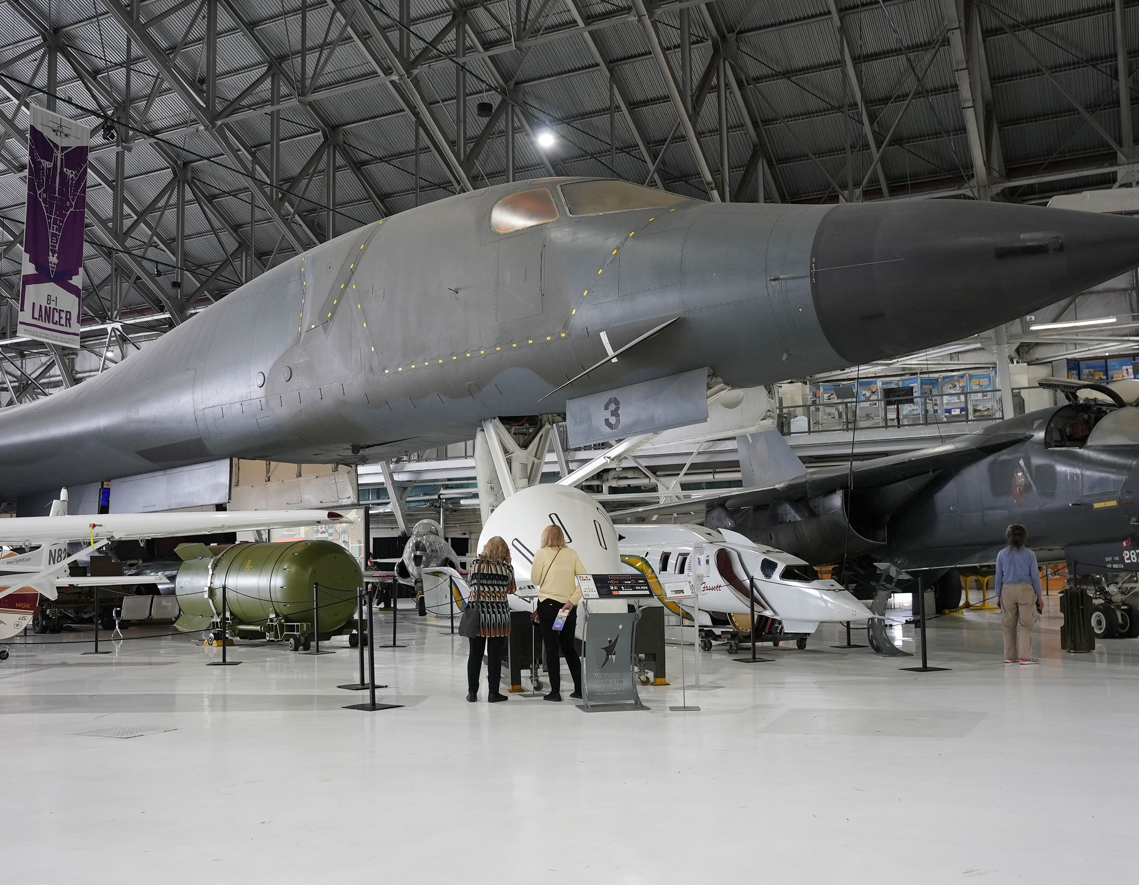 Guests standing under the B-1A Lancer at the Air & Space Museum