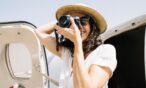 Photographer taking a photo and standing next to airplane