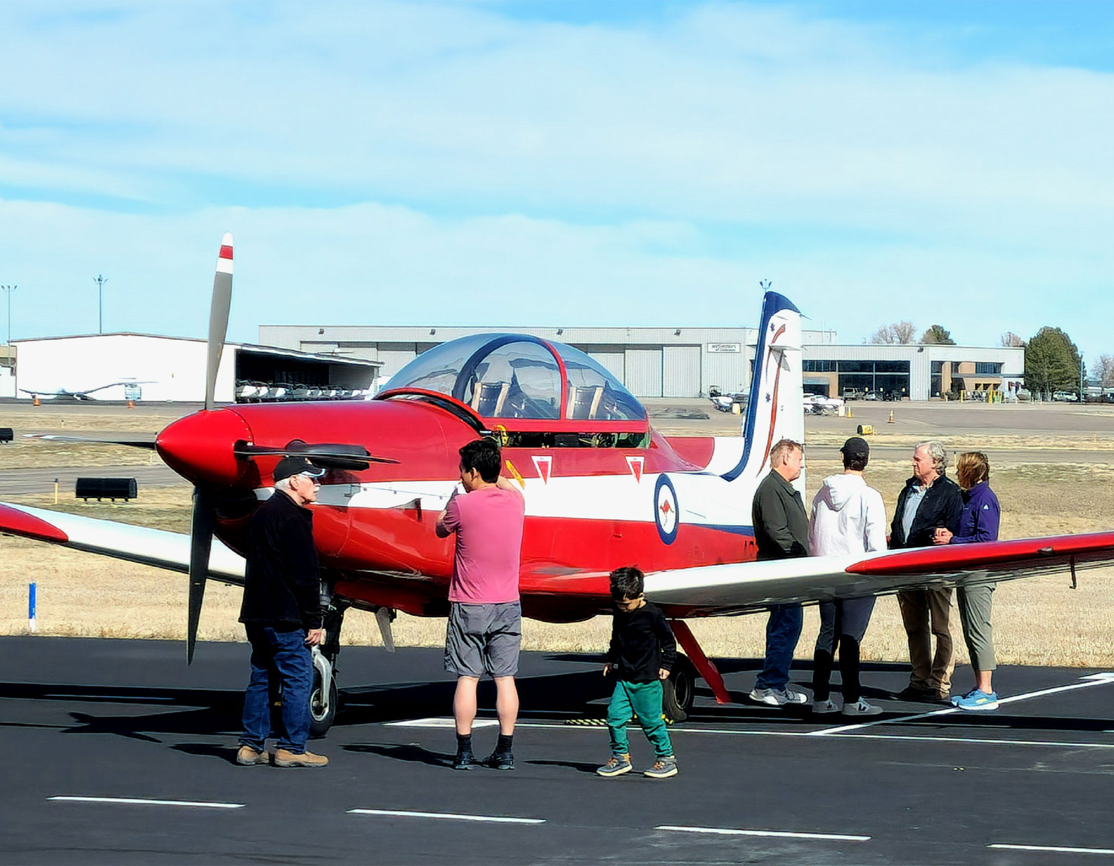 Guests standing by aircraft on the ramp at Exploration of Flight