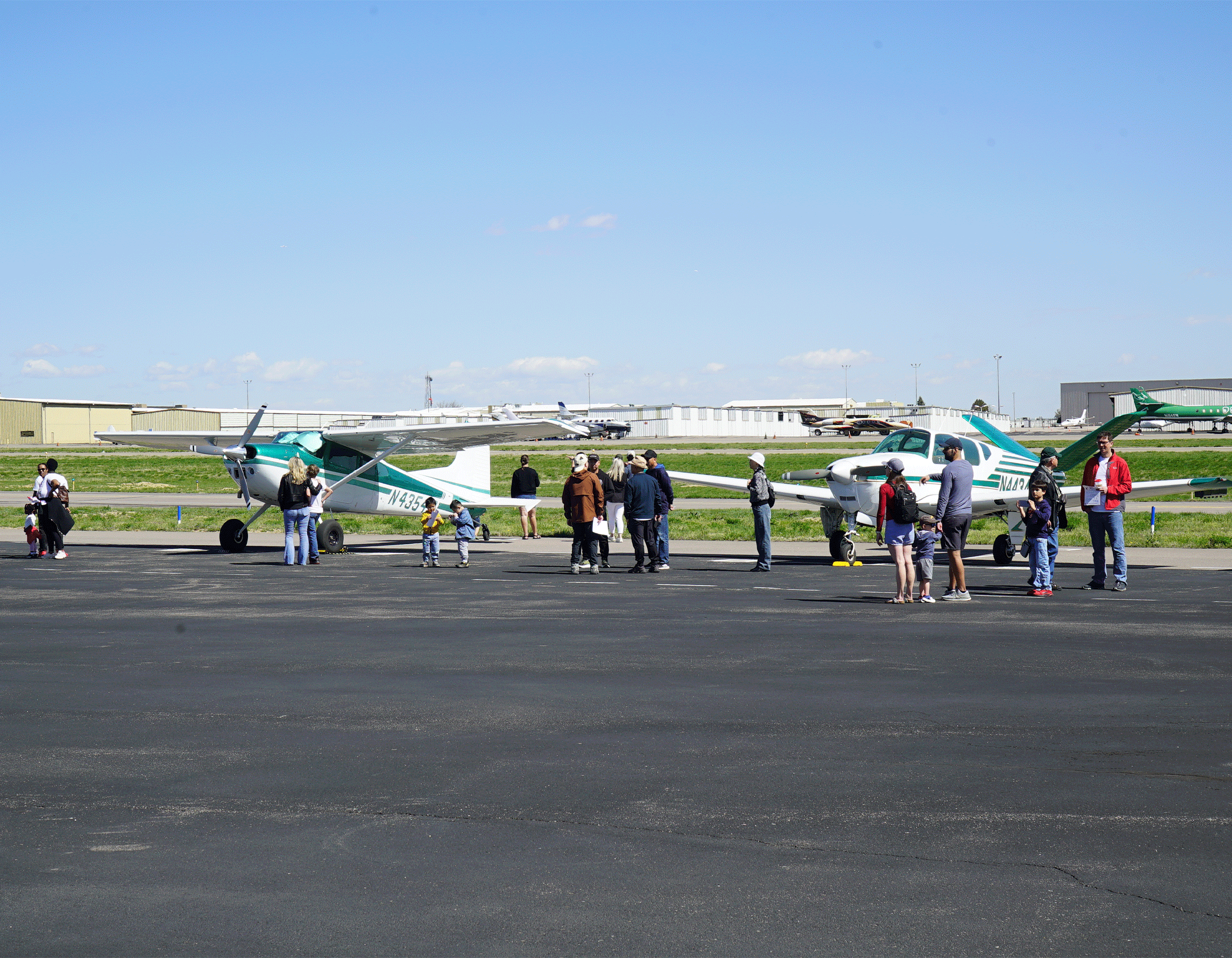 Various families looking at aircraft on the ramp at Exploration of Flight