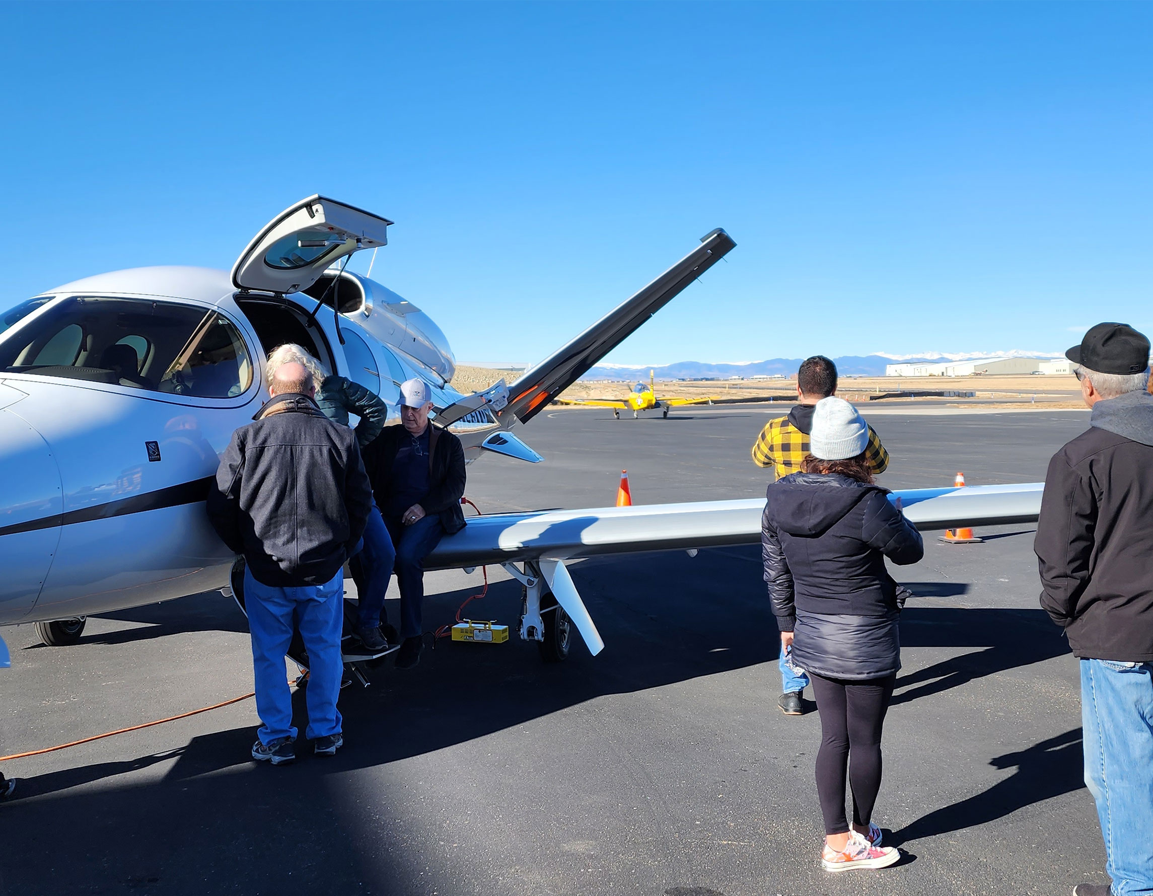 Guests at Exploration of Flight checking out an airplane on the ramp