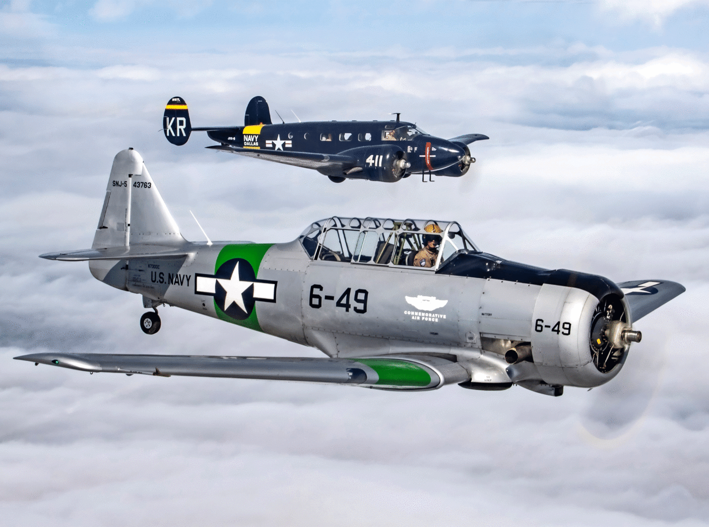 C-45 and SNJ Airplanes flying next to each other