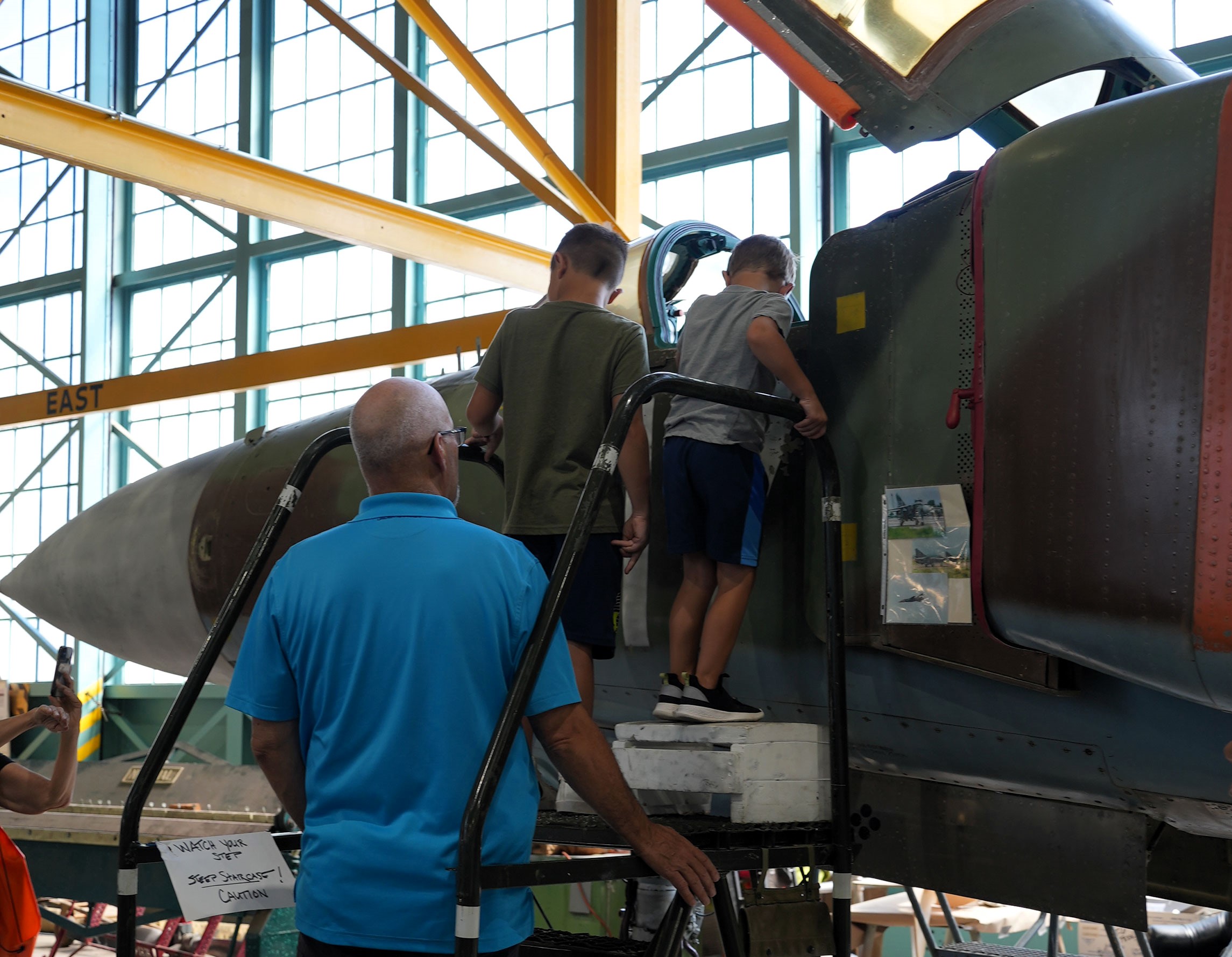 Kids looking inside the cockpit of the MiG-23