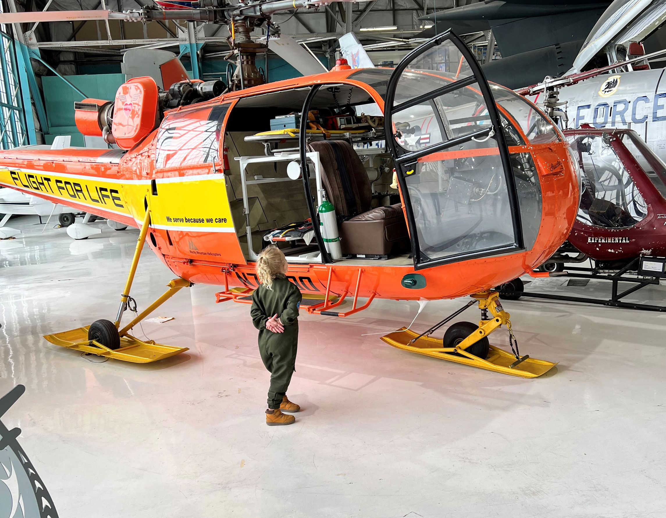 Young girl looking into the cockpit of the Aerospatiale AS316 Alouette III