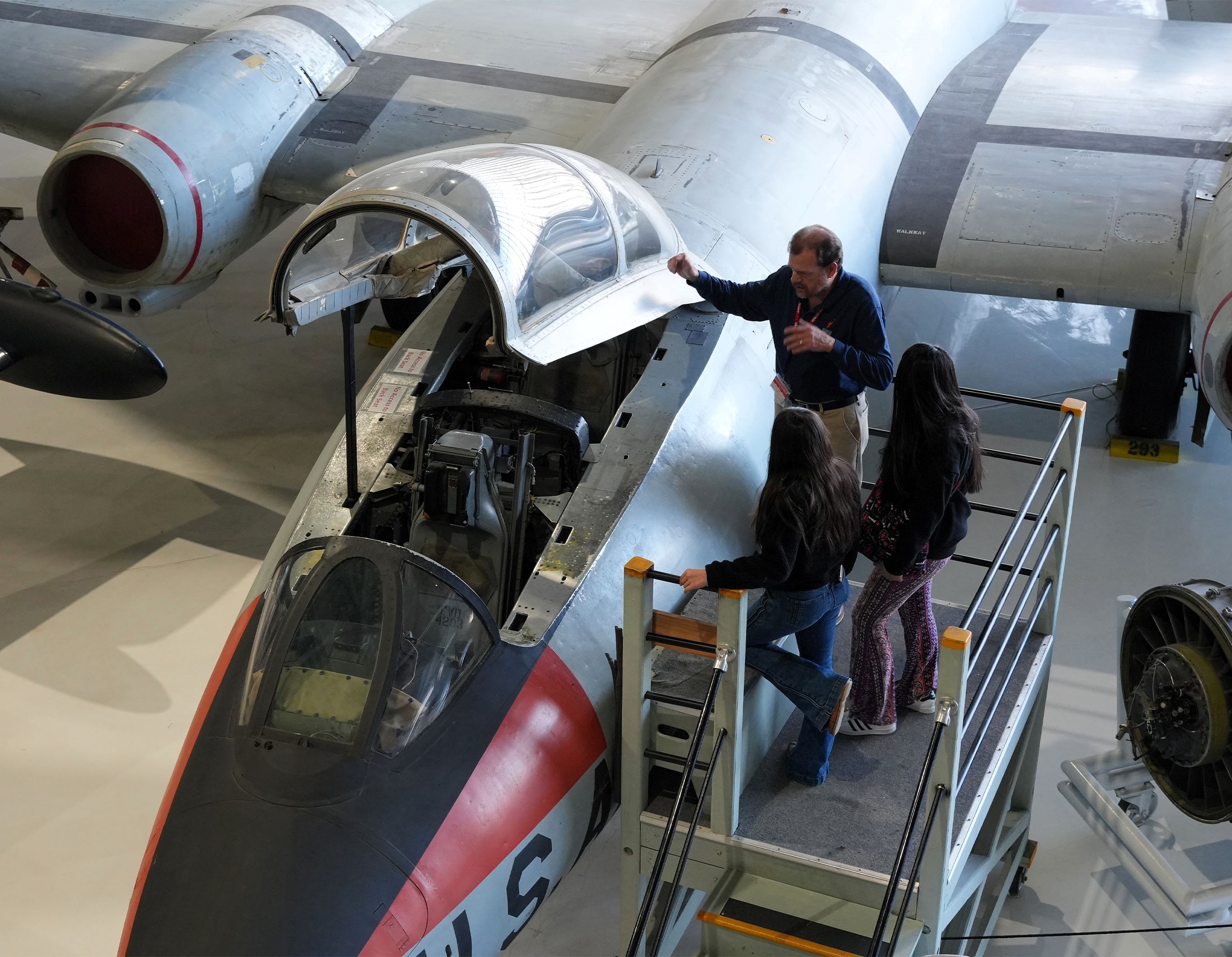 Volunteer showing guests the inside of a cockpit