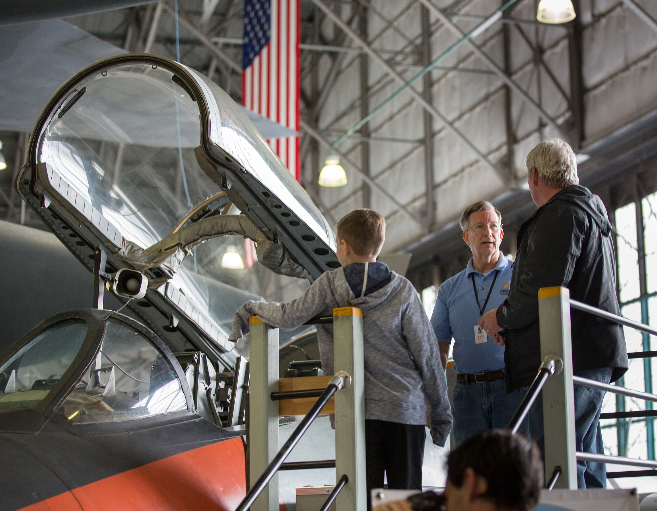 Guests talk with a volunteer at an open cockpit