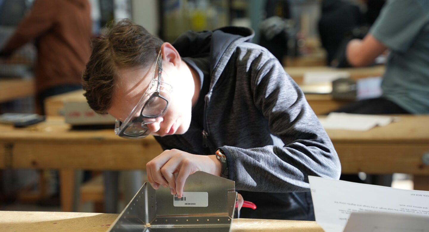 Wings Aerospace Exploration student working with toolbox