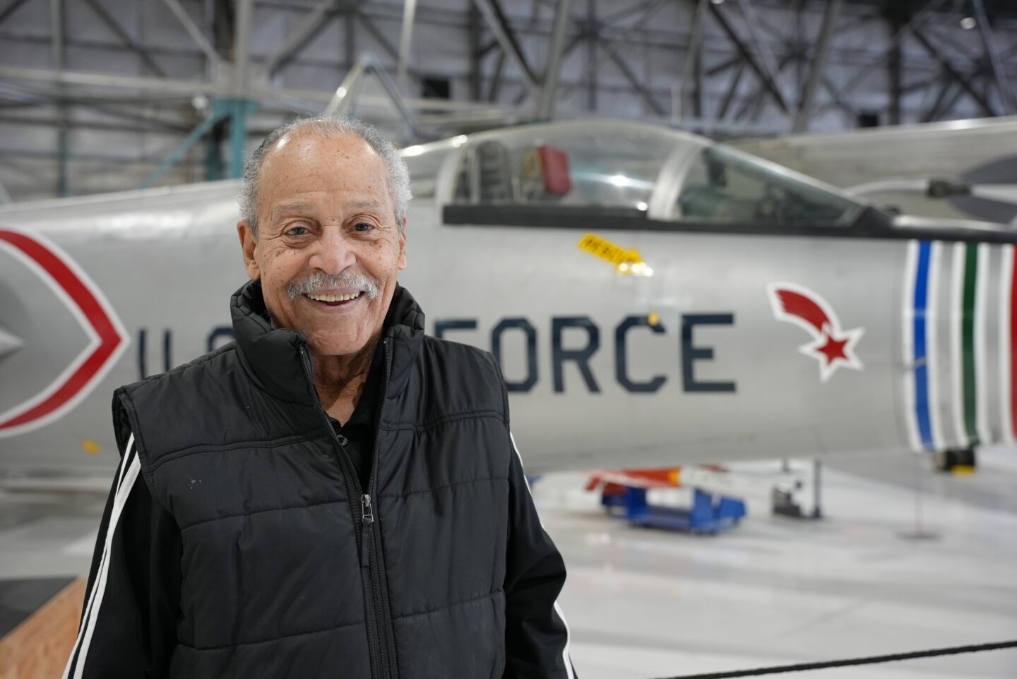 Ed Dwight smiling in front of the F-104 at the Air & Space Museum