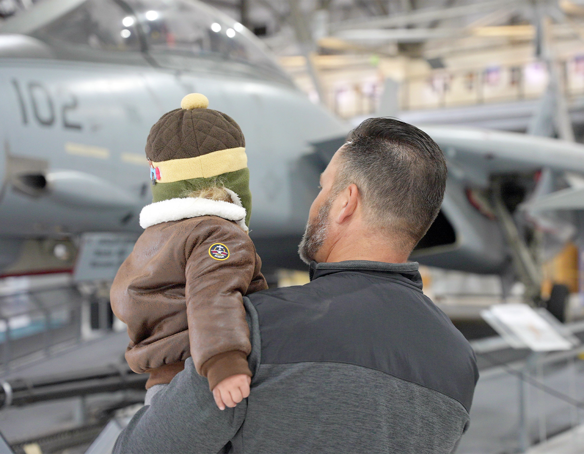 Father and son looking at an airplane in the museum