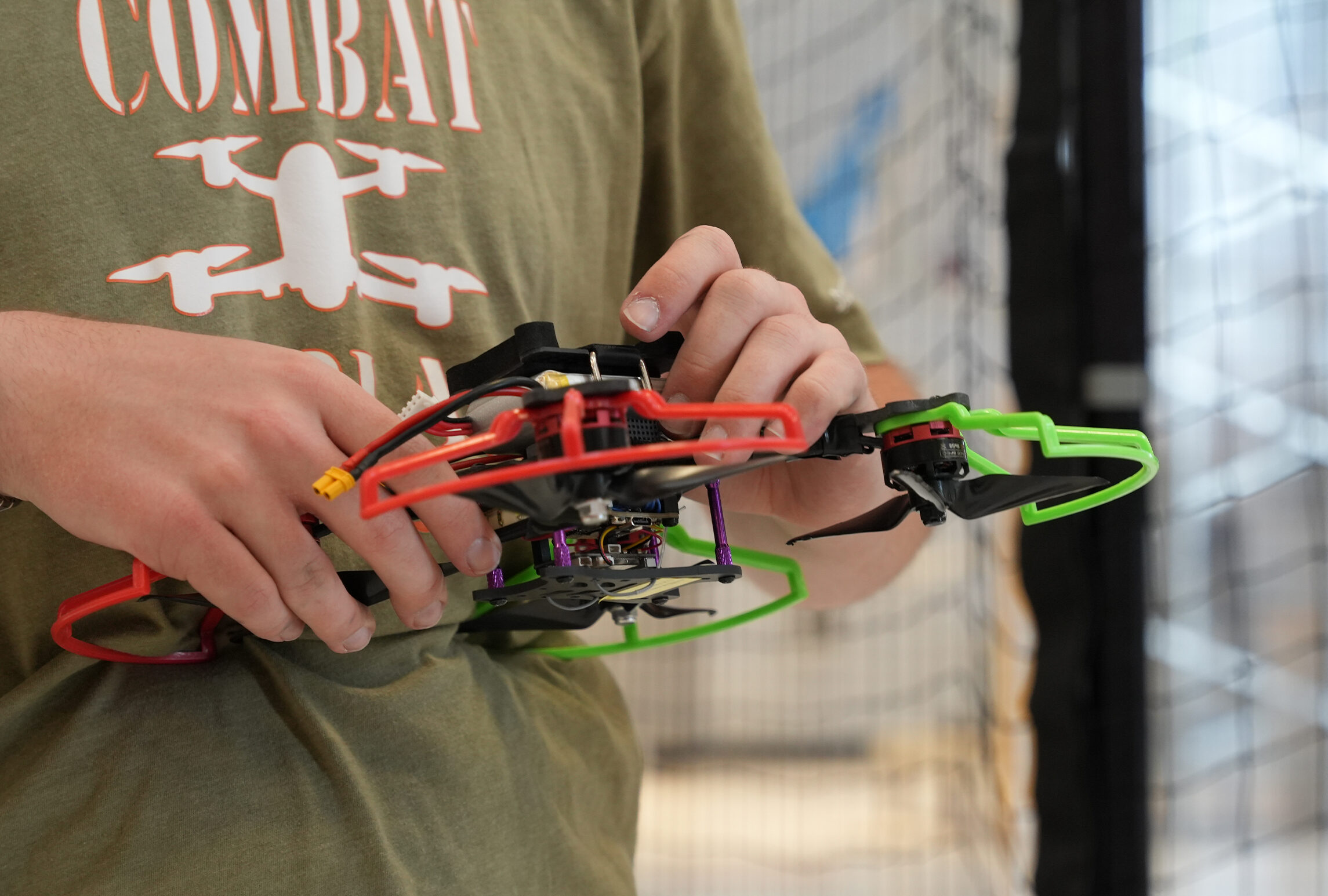 Students putting the battery into a drone