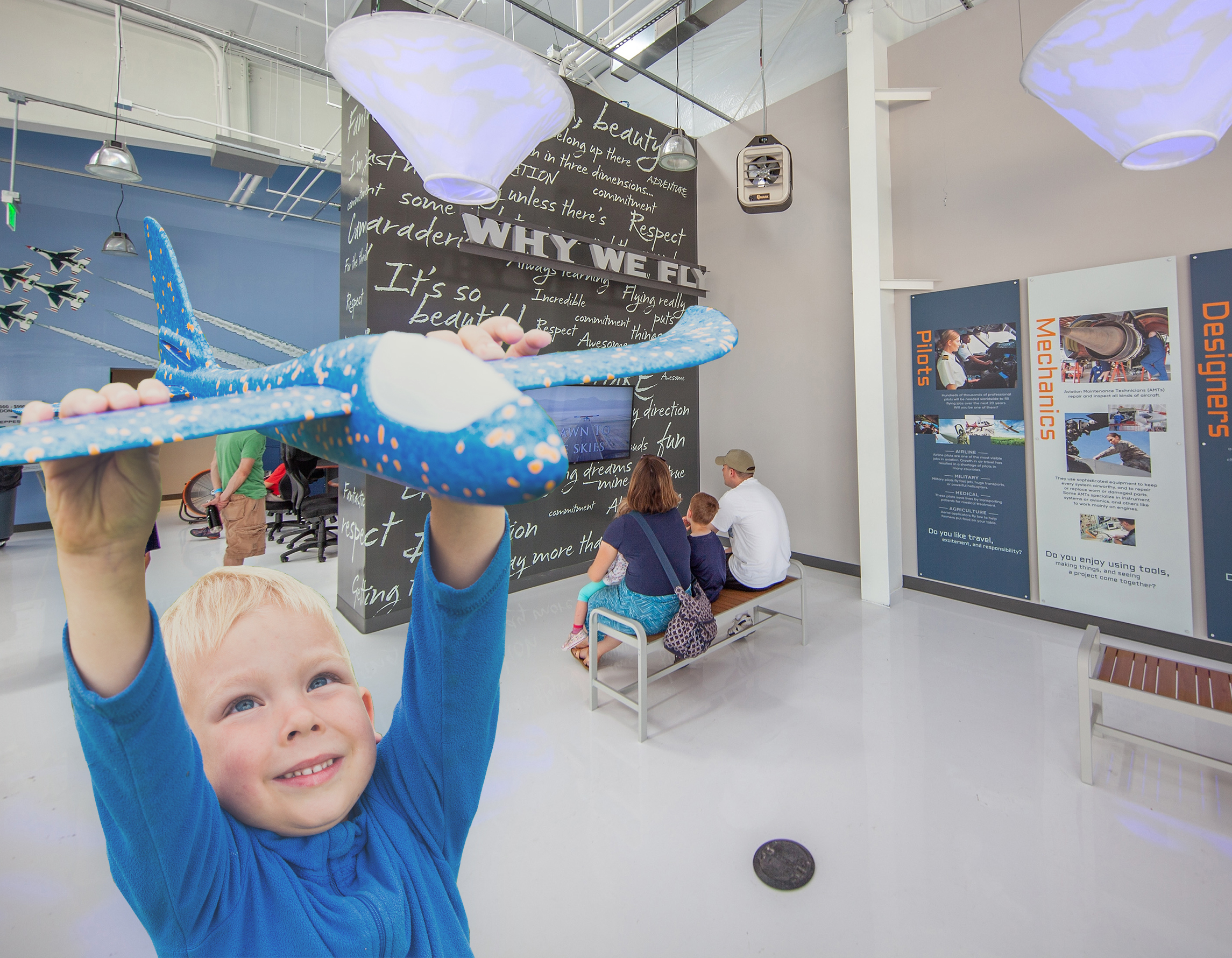 Little boy holding a toy airplane inside Exploration of Flight