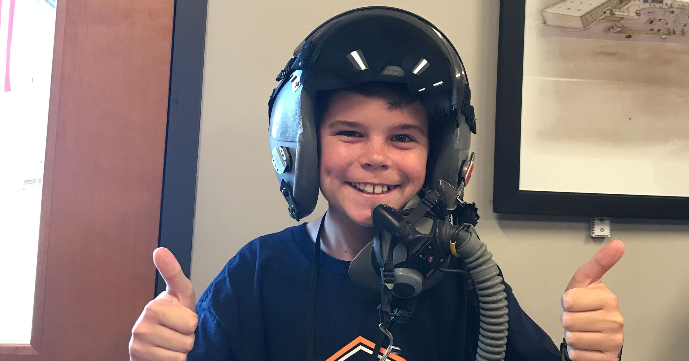 Camper grinning in a fighter pilot helmet