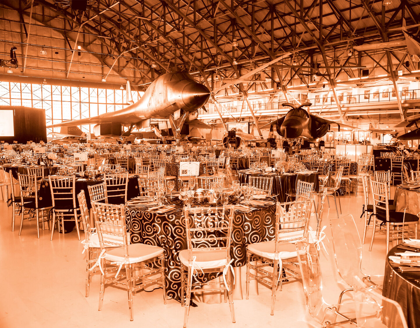Hangar full of tables and chairs for private event
