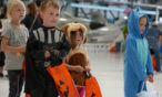 Children in Halloween costumes in the hangar