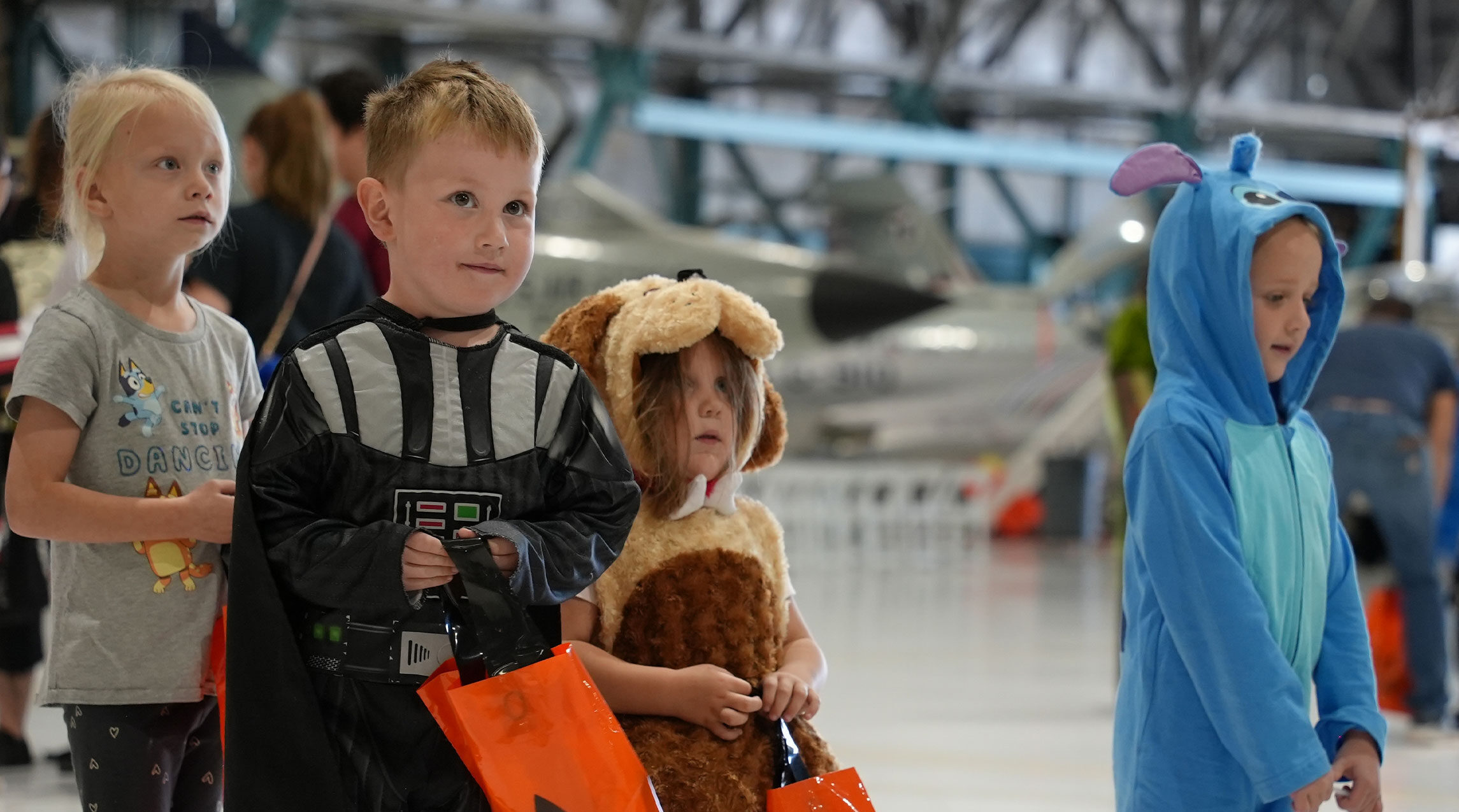 Children in Halloween costumes in the hangar