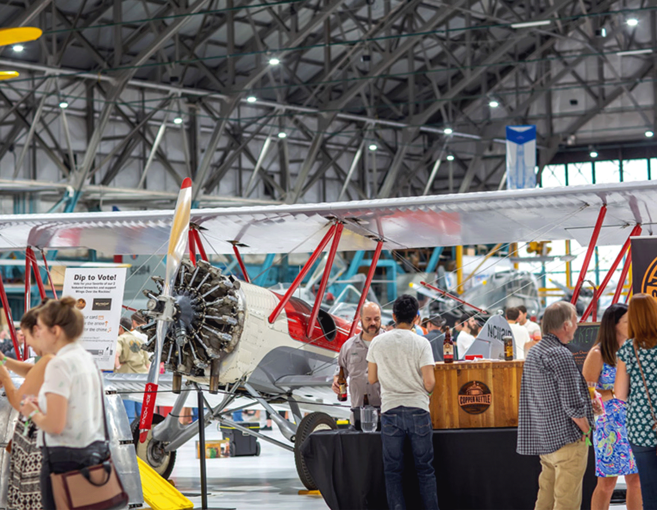Guests at a brewery booth at Hops in the Hangar