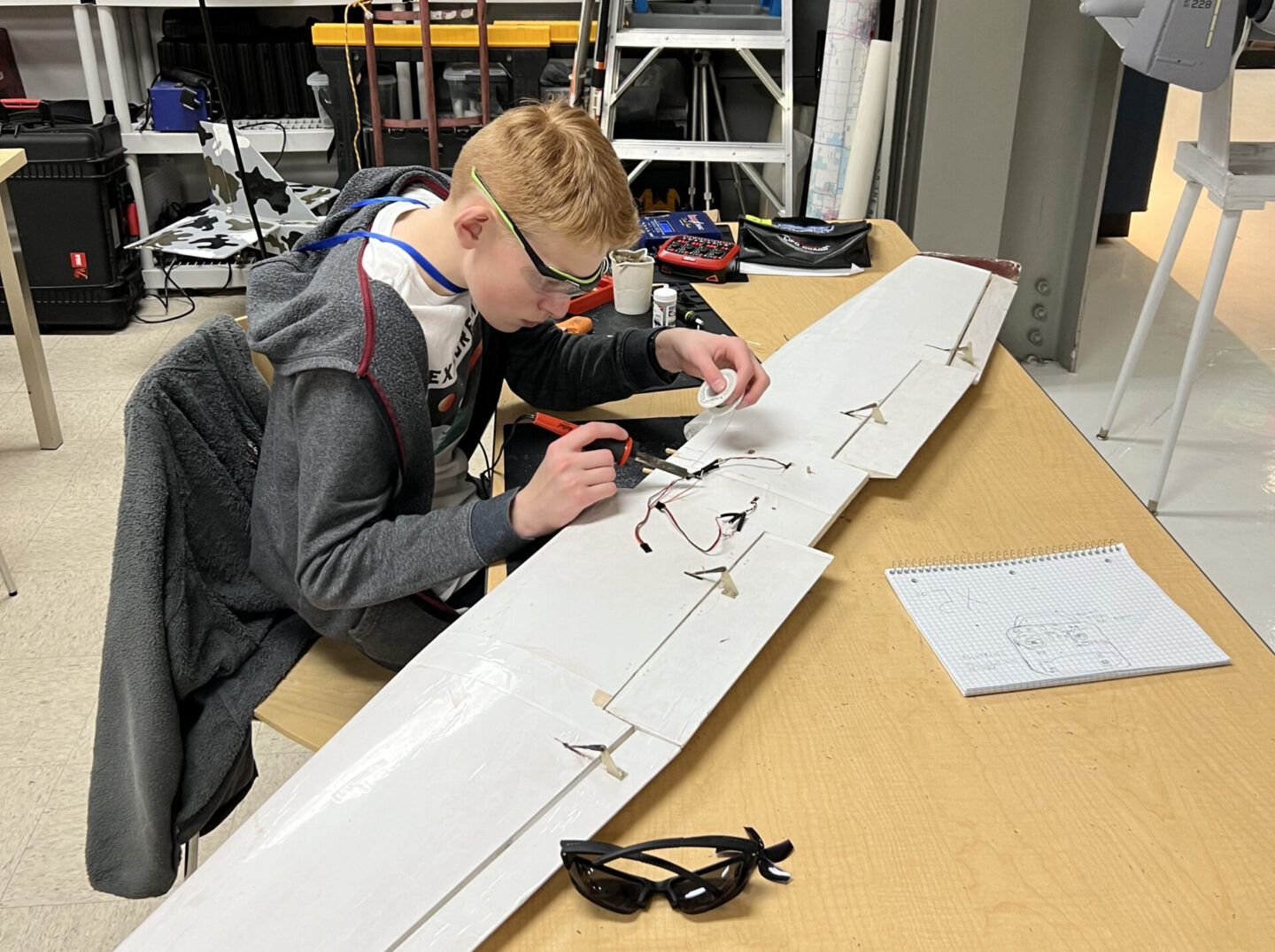 Students working on model airplane wing