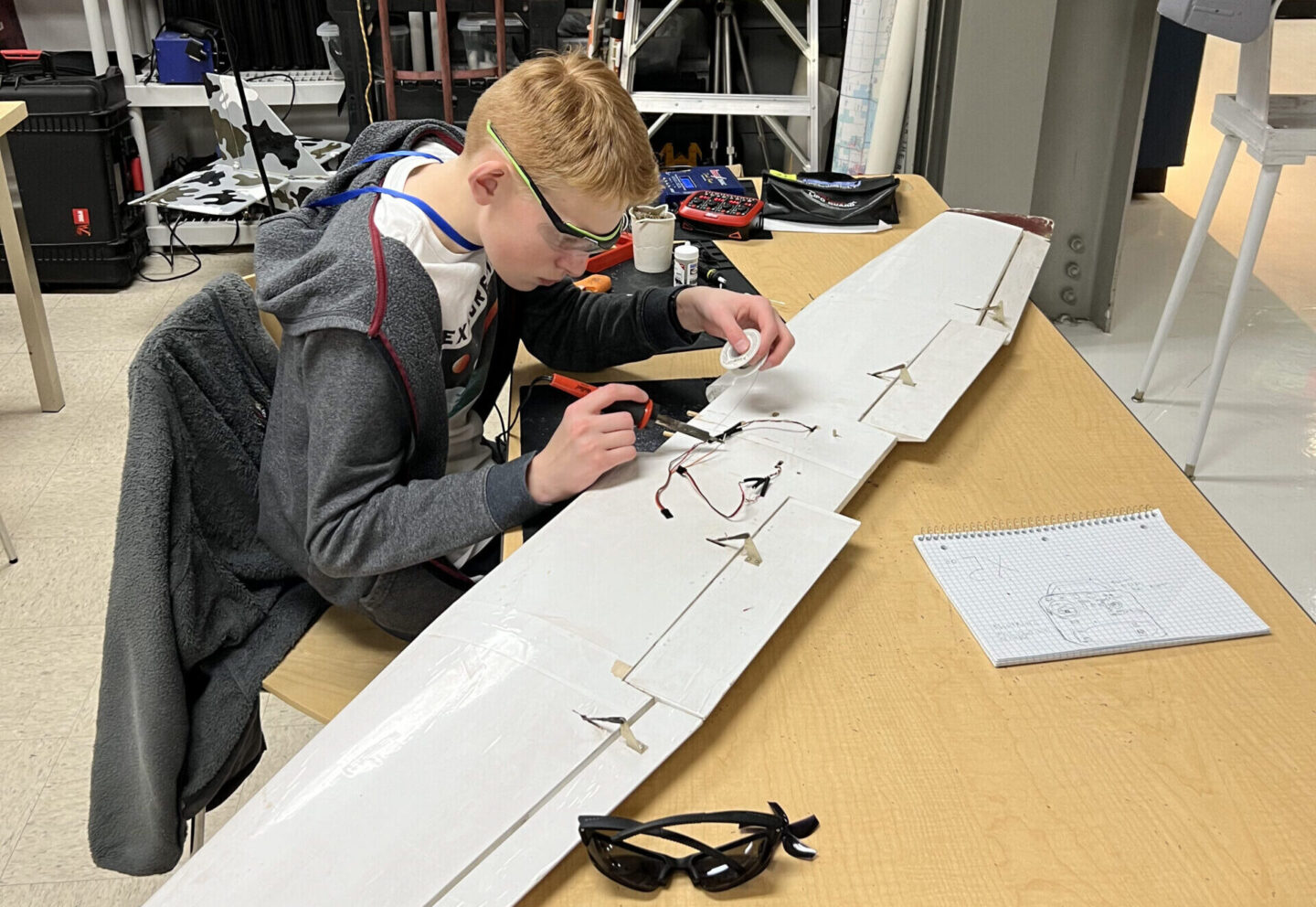 Students working on model airplane wing