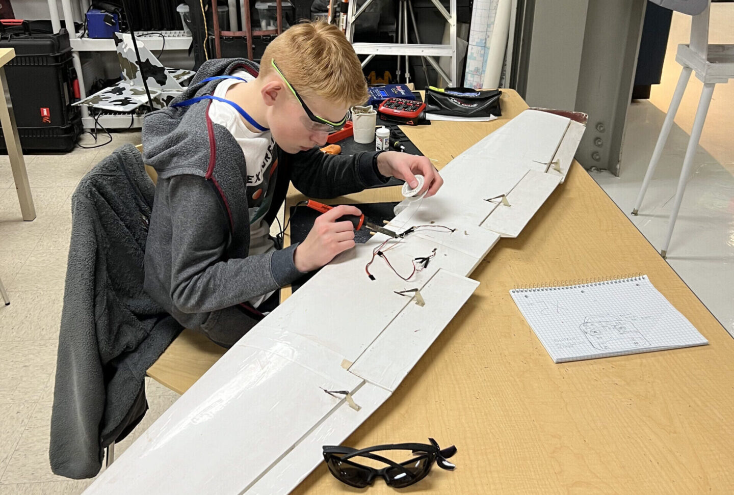 Students working on model airplane wing