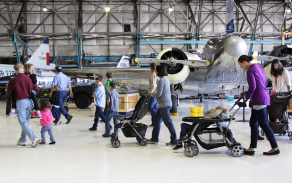 A family walking in front of aircraft at the Air & Space Museum