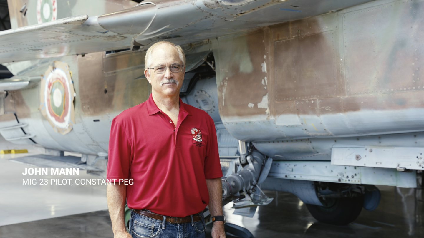 John Mann standing next to the MiG-23