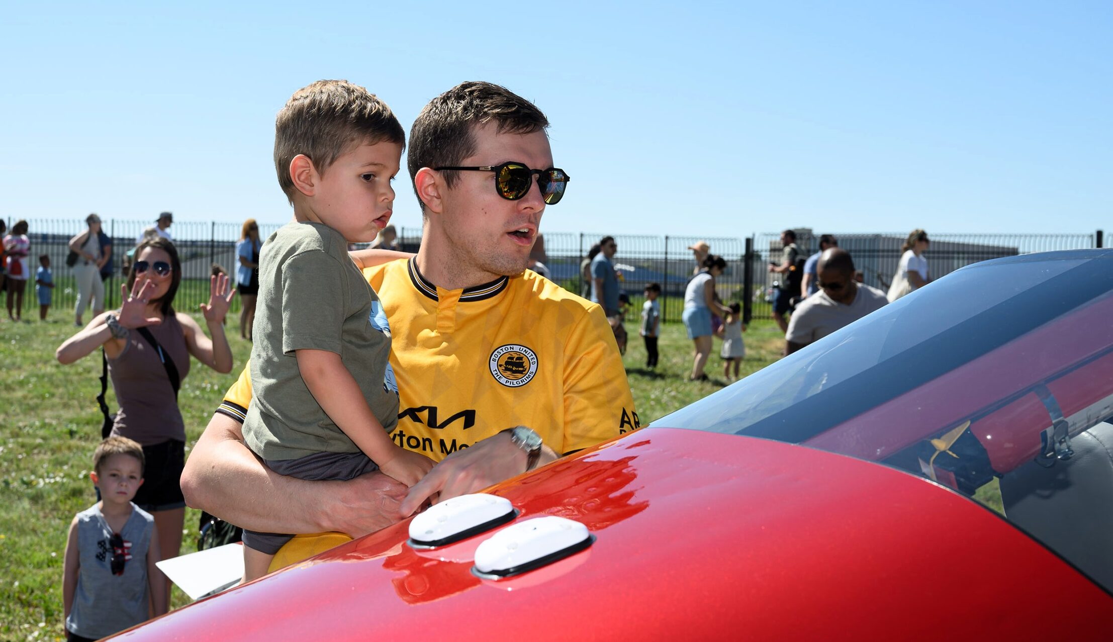 Father holding son as they check out aircraft on the ramp at Exploration of Flight
