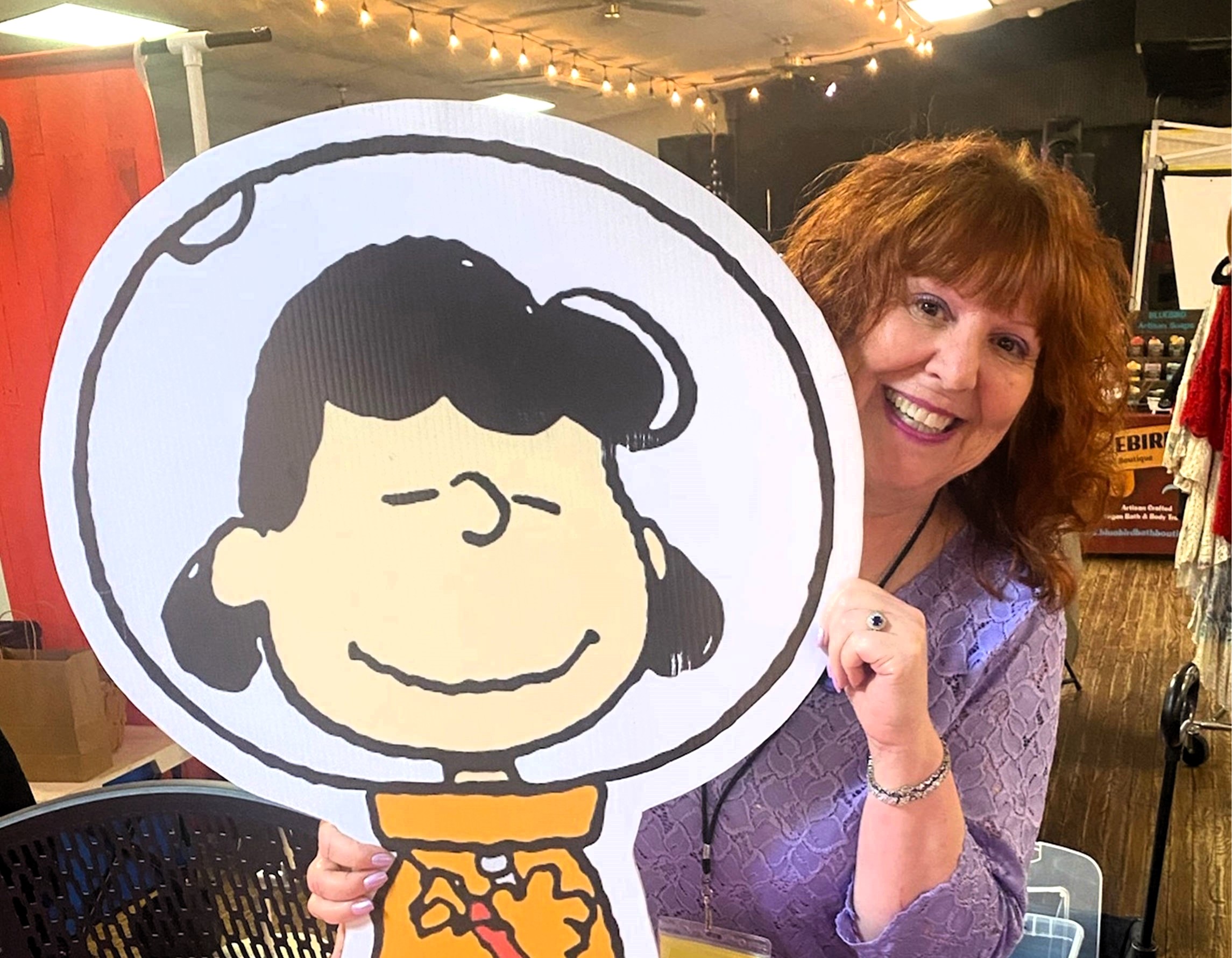 Melanie Kohn, the voice of Lucy van Pelt, holding up a photo of Lucy