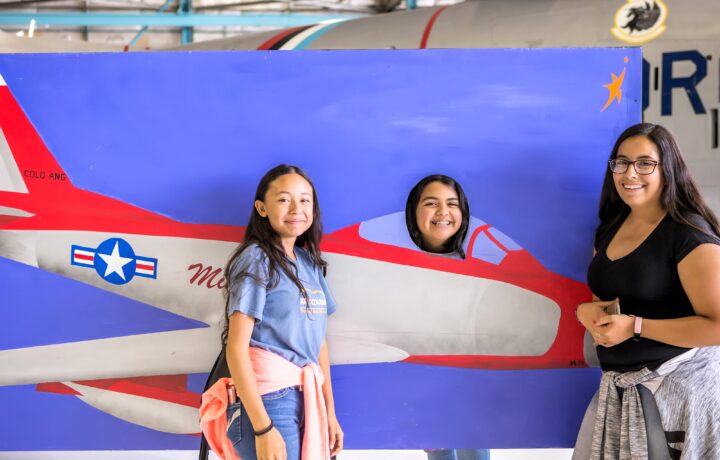 Three girls smiling at the Air & Space Museum