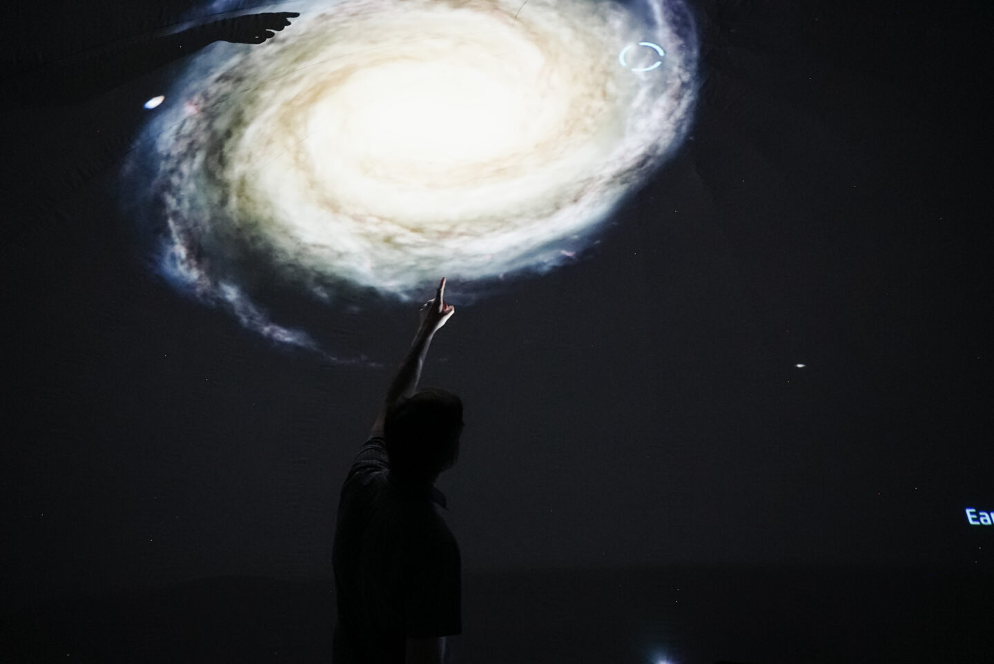Guide points to galaxy in the Wingsphere planetarium