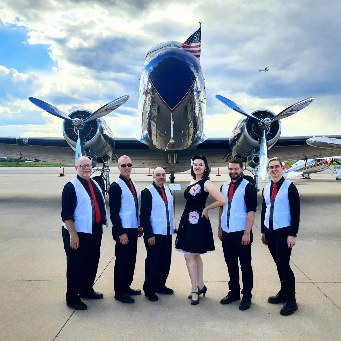 Bianca & The Flyboys in front of an airplane