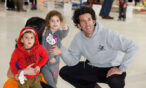 Family pointing and smiling at the Air & Space Museum.