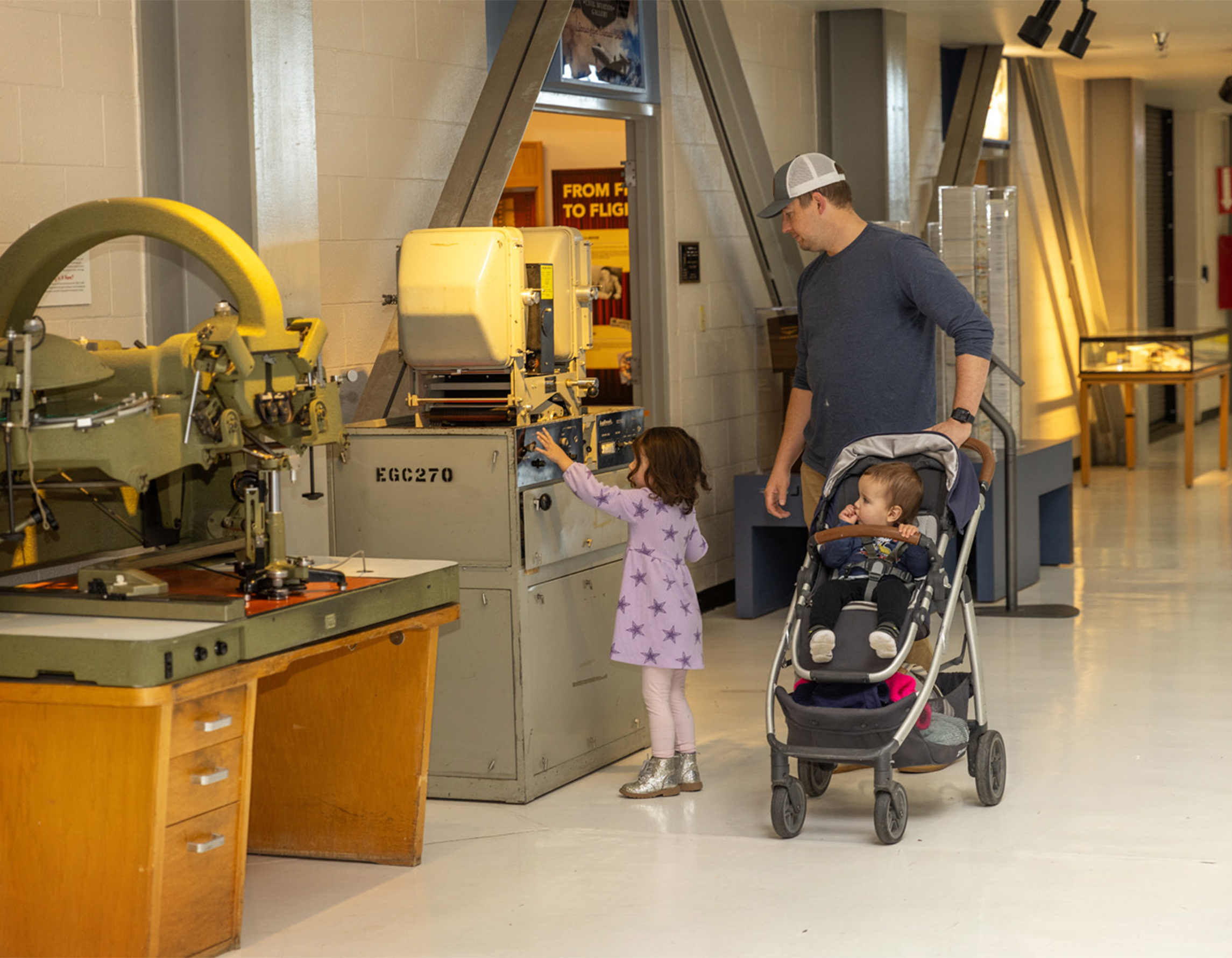 Dad and two kids exploring exhibits at the Air & Space Museum