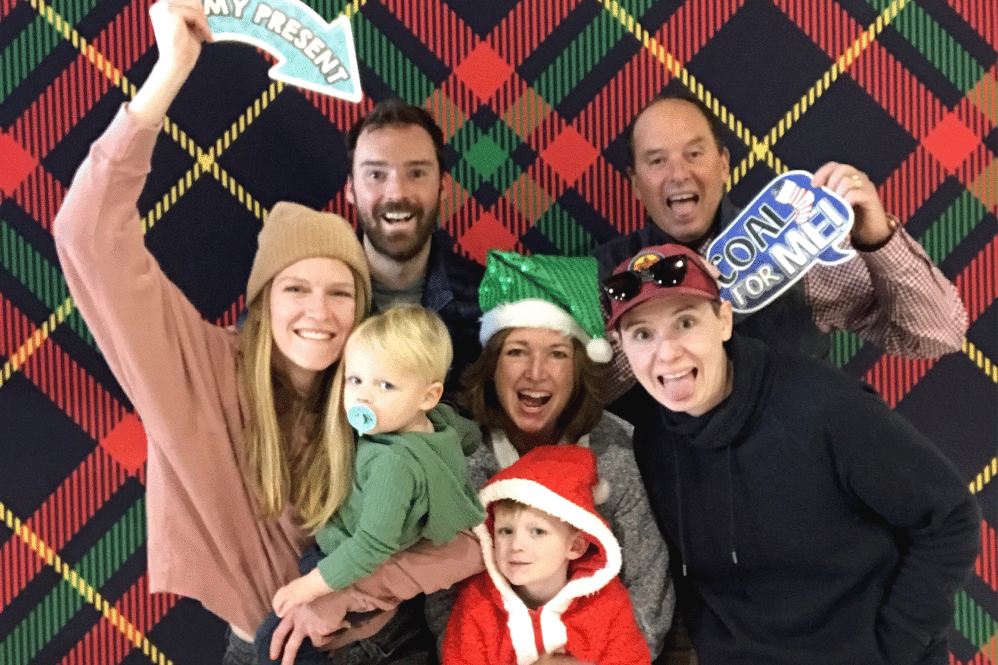 Holiday photo booth of family smiling