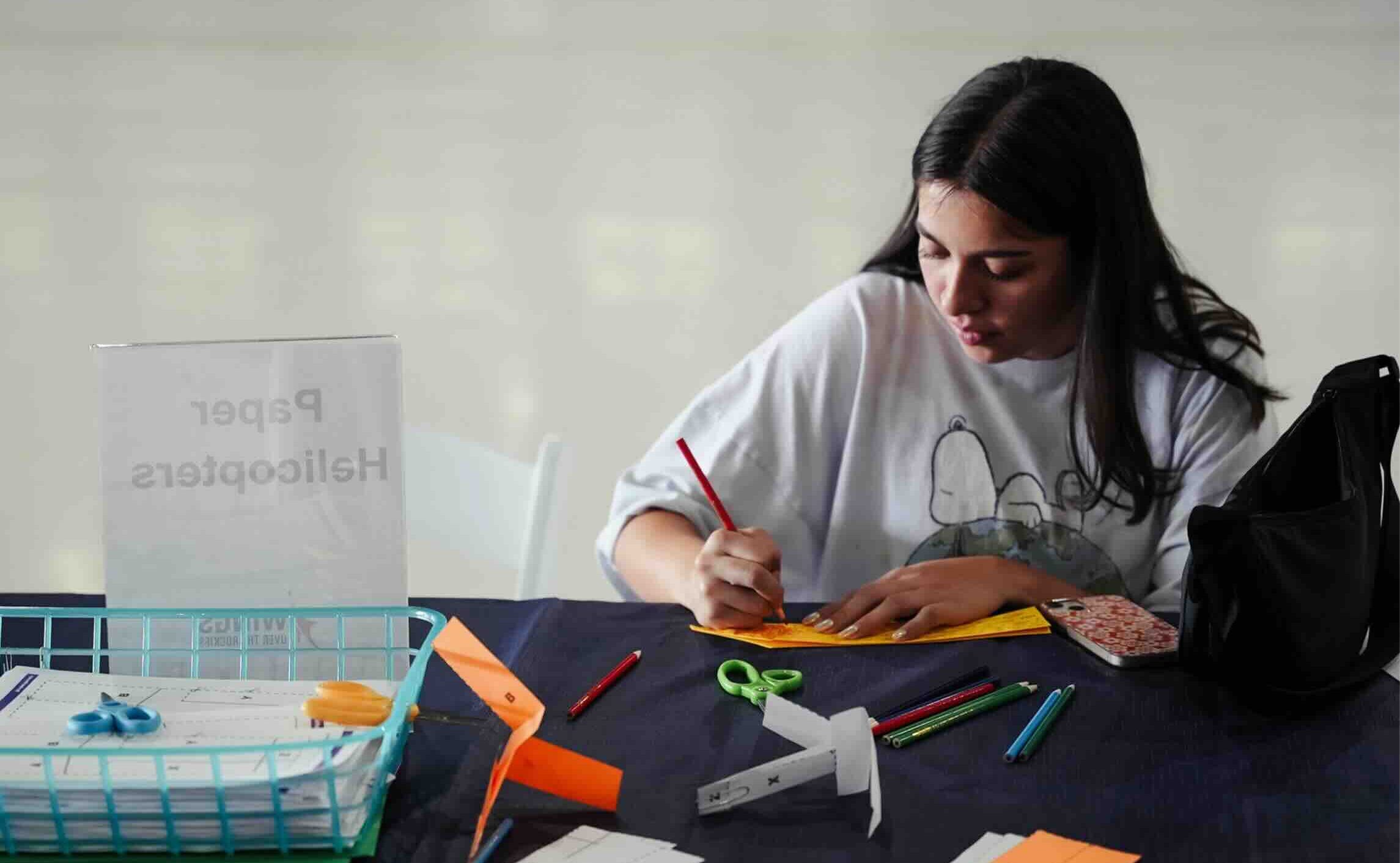 Girl doing hands-on activity during Sensory Friendly Hours