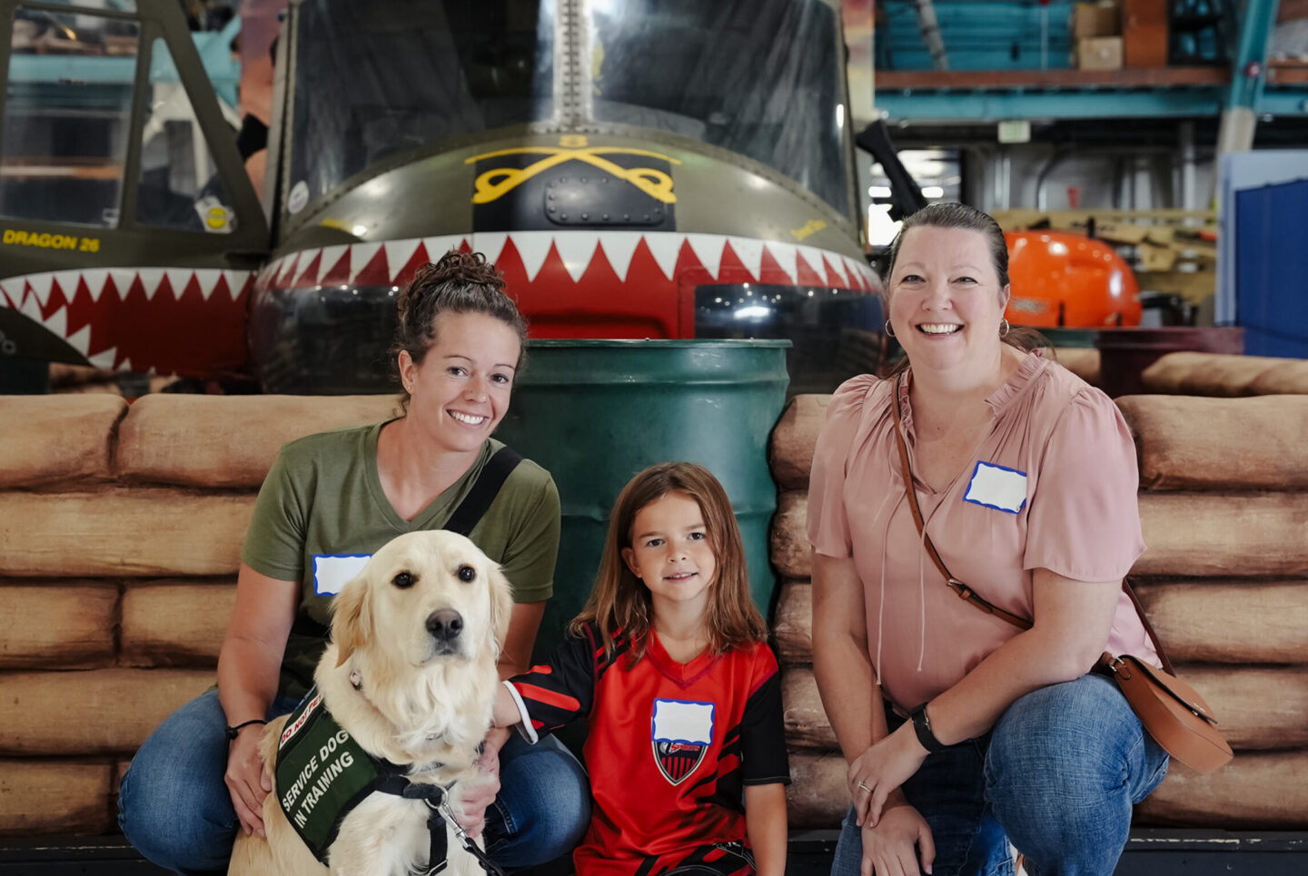 Family smiling at the museum during Veterans Coffee Hour