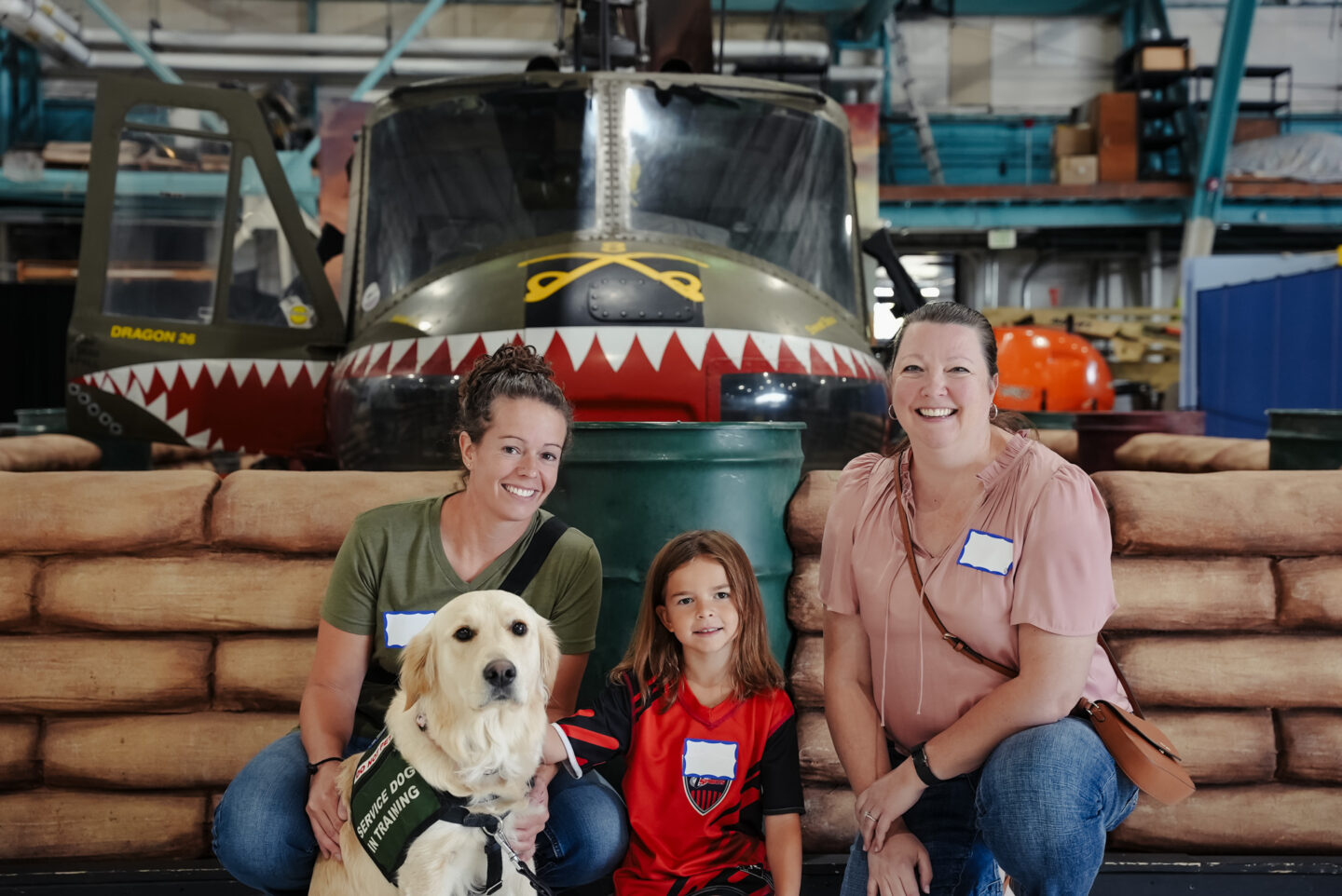 Veterans with child and dog smiling during Veterans Coffee Hour