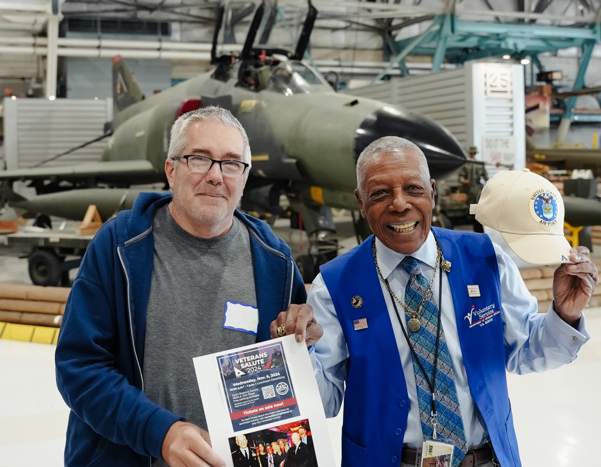 Two veterans smiling in the hangar