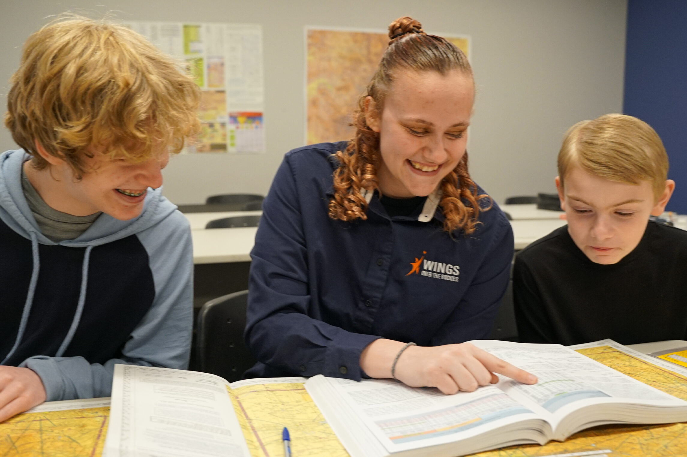 Wings Aerospace Exploration students smiling while reading