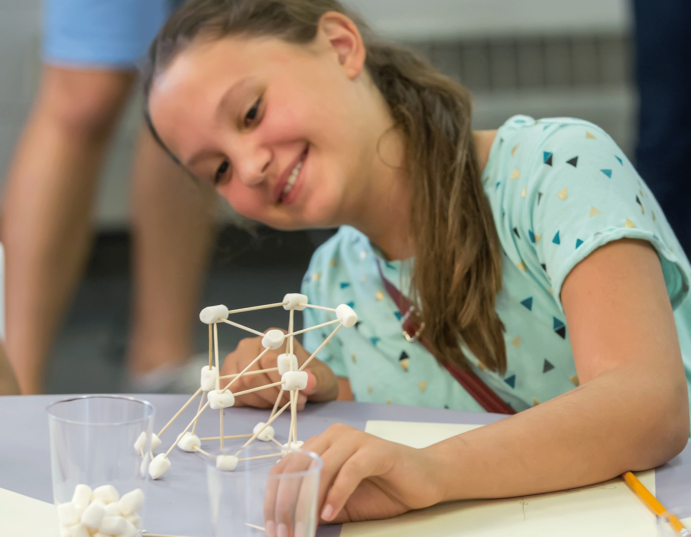 Student doing activity with marshmallows and toothpicks