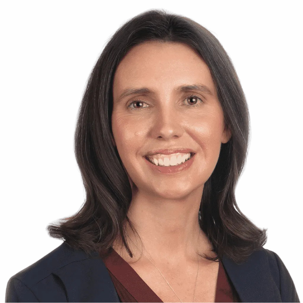 Angie Wise is posing for a portrait photo. She is wearing black and standing in front of a white background.