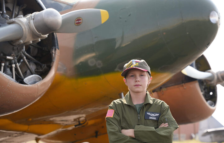 Wings Museum Memberships - Kid standing next to plane