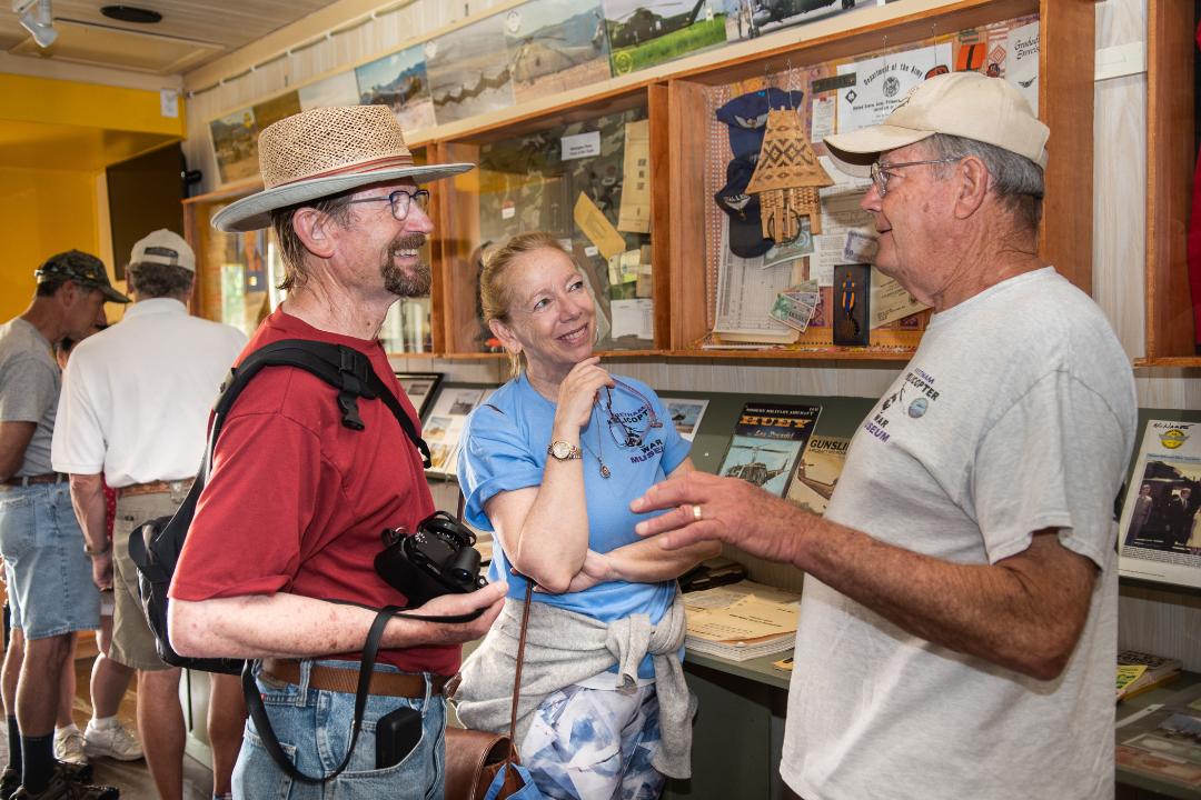 Guests interacting with a volunteer in the Vietnam Helicopter Museum